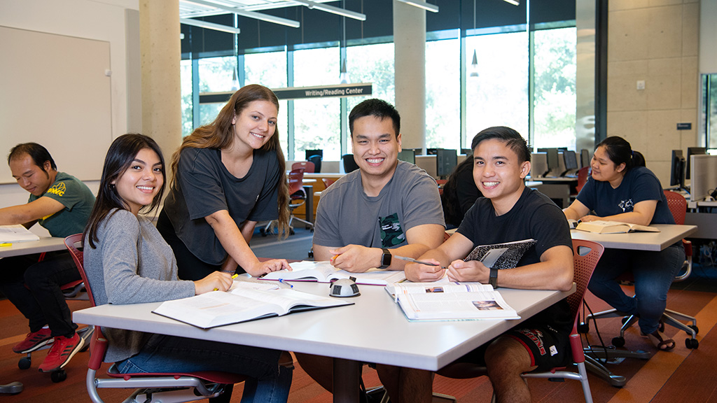 Four students collaborating on a English assignment