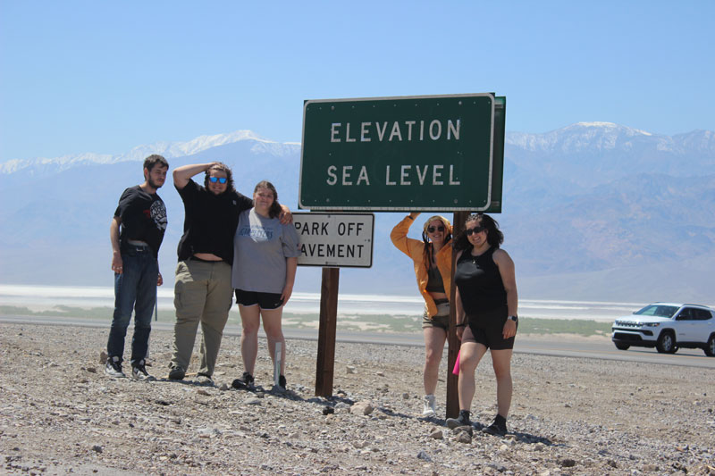 students infront of the at Sea Level sign