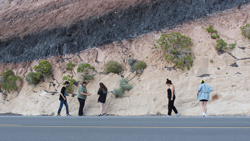 students surveying rock formations
