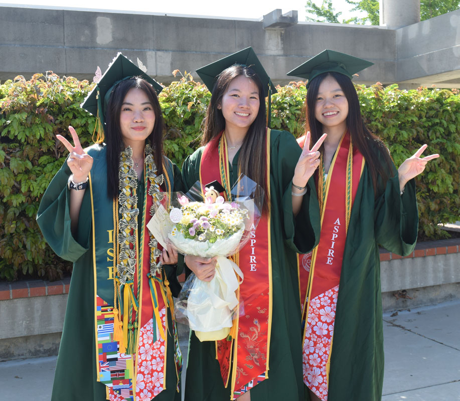 3 GWC Aspire graduating students in cab and gown