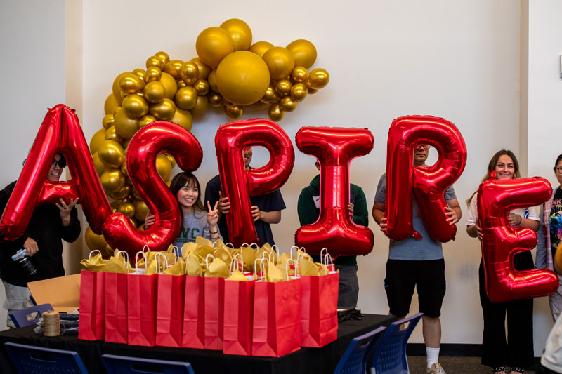 Aspire Graduation behind Aspire balloons and gifts