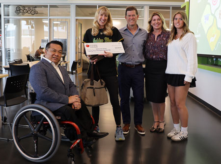GWC professor Kate Green poses with OCDE Superintendent Stefan Bean and the Gross Family