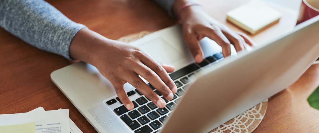 Student hands on keyboard registering at GWC.jpg